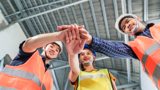 A group of people joining hands to work together. Teamwork cooperation concept. stock photo