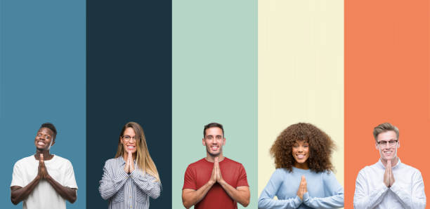 Group of people over vintage colors background praying with hands together asking for forgiveness smiling confident.  prayer request stock pictures, royalty-free photos & images