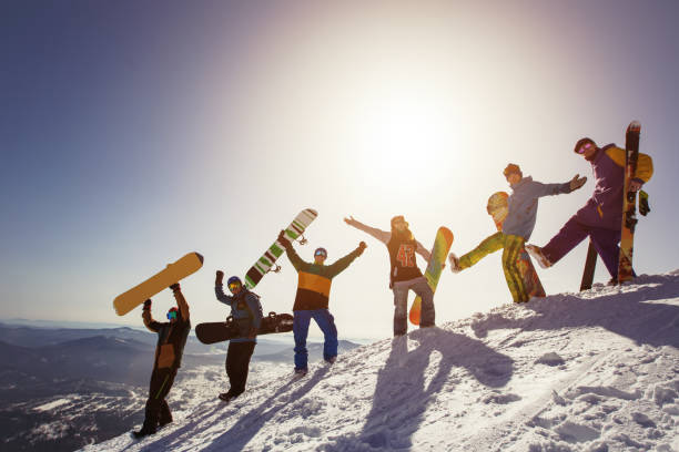 group of people snowboarders and skiers on mountain sunset. winter sport outdoor - kemerovo imagens e fotografias de stock