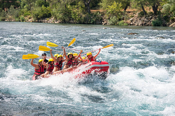 Group of people white water rafting Group of people white water rafting. The raft goes through a big rapid on Koprulu Canyon near Antalya, Turkey inflatable raft stock pictures, royalty-free photos & images