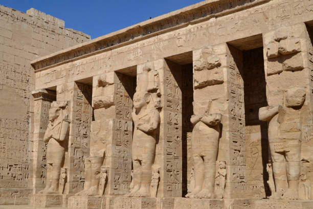 A group of Pharaonic pillars made of stone from Habu temple( Medinet Habu ) Luxor Governorate, Egypt A group of Pharaonic pillars made of stone from Habu temple( Medinet Habu ) Luxor Governorate, Egypt empire stock pictures, royalty-free photos & images
