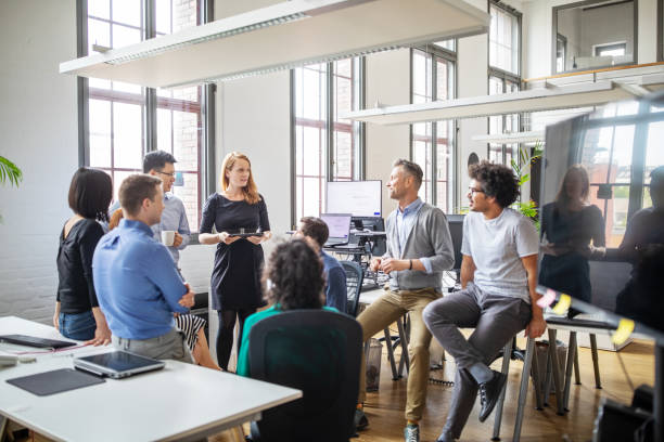 Group of professionals discussing new business plan Multi-ethnic business people sharing ideas in a modern office. Group of professionals discussing new business plan in meeting. brainstorming photos stock pictures, royalty-free photos & images