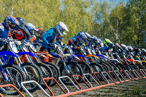 group of riders on motorcycles starting line ready to start stock photo