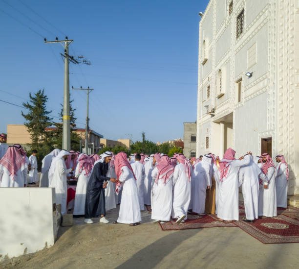 A group of Saudis in Saudi dress next to the mosque on May 2, 2022 stock photo