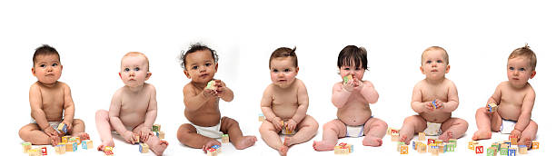 Group of Seven Babies - Ethnic Diversity Color image of seven adorable babies sitting in a row, playing with blocks.  Multi-racial and diverse. cute arab girls stock pictures, royalty-free photos & images