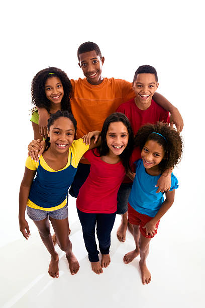 Group of six teenagers smiling and embracing stock photo