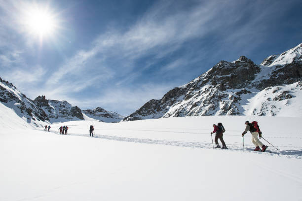Group of ski mountaineers during a trip on the alps stock photo