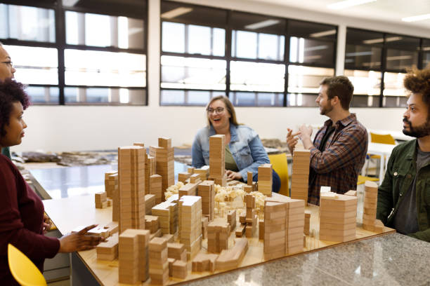 Group of students talking around a city model stock photo