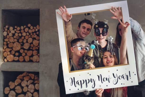 Group of teenagers having New Year Party Group of teenagers having a new year eve party. 15 , 17 and 18 years old.  Note there is non alcoholic beverage. happy new year dog stock pictures, royalty-free photos & images
