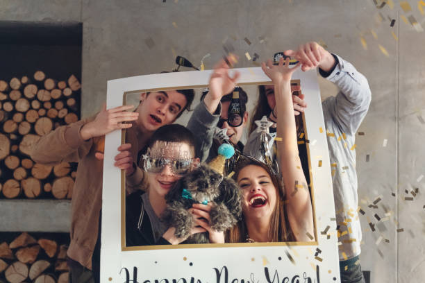 Group of teenagers having New Year Party Group of teenagers having a new year eve party. 15 , 17 and 18 years old.  Note there is non alcoholic beverage. happy new year dog stock pictures, royalty-free photos & images