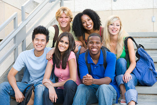 Group of university students sitting on steps Group of six students outside sitting on steps university student photos stock pictures, royalty-free photos & images