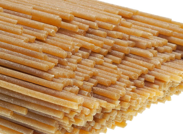 A group of whole wheat spaghetti on white background stock photo