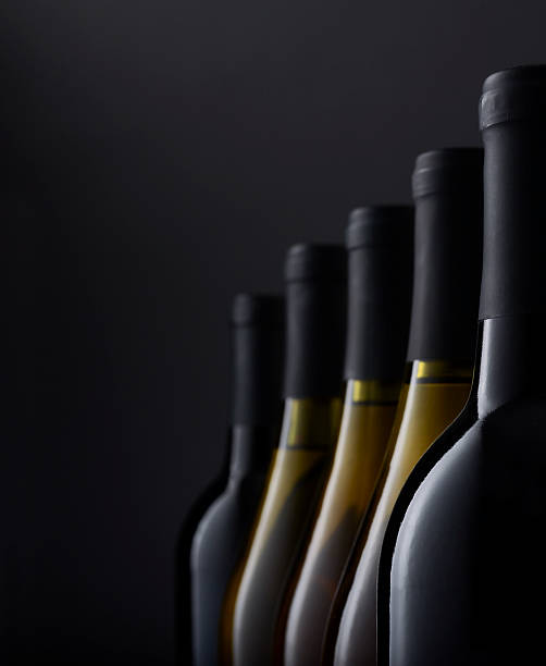 Group of Wine bottles in window light stock photo