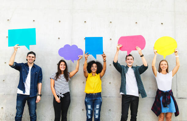 Group of young adults outdoors holding empty placard copyspace thought bubbles Group of young adults outdoors holding empty placard copyspace thought bubbles generation z photos stock pictures, royalty-free photos & images