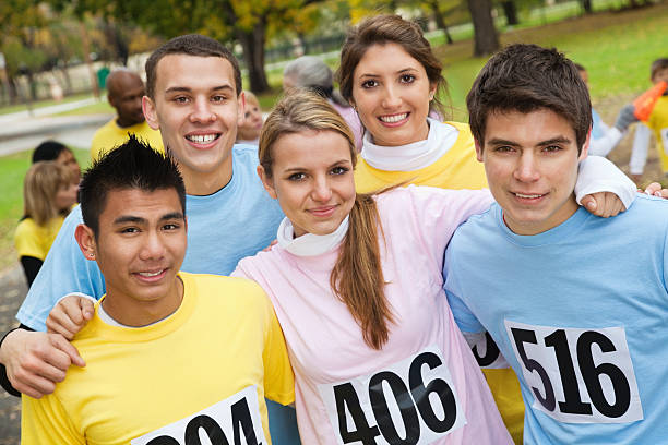 Group of young friends at a charity race Group of young friends at a charity race. teenage boys men blond hair muscular build stock pictures, royalty-free photos & images