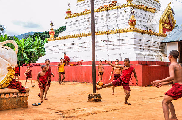 group of young monks playing chinlone at pindaya, myanmar - ayak voleybolu stok fotoğraflar ve resimler