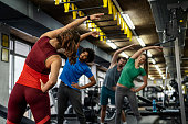 istock Group of young people doing exercises in gym 1316679178