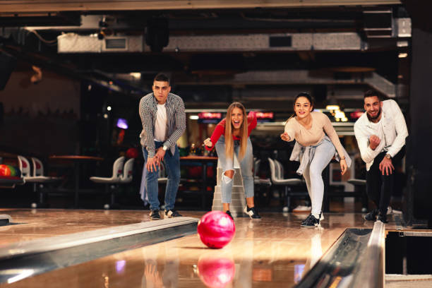 Group of young people having fun in a bowling alley stock photo