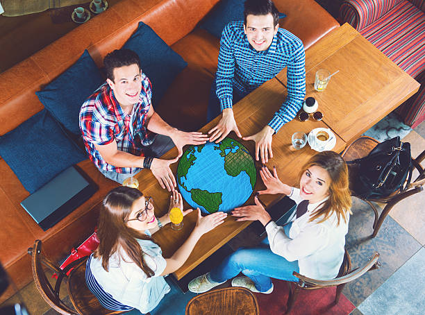 Group of young people with a drawing of a planet Earth stock photo