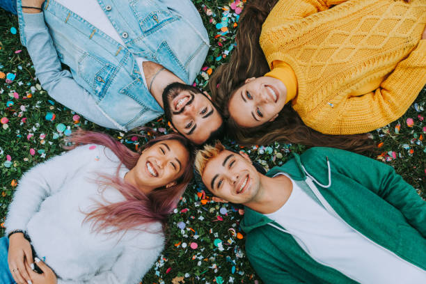 Group of young students bonding outdoors Happy young people meeting outdoors - Group of cheerful teenagers having fun, concepts about teenage, lifestyle and generation z generation z stock pictures, royalty-free photos & images