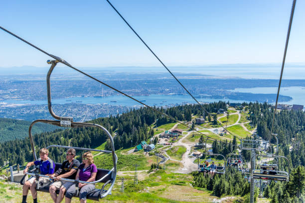 Grouse Mountain chair lift, windmill and wood carvings are some of the sights here stock photo
