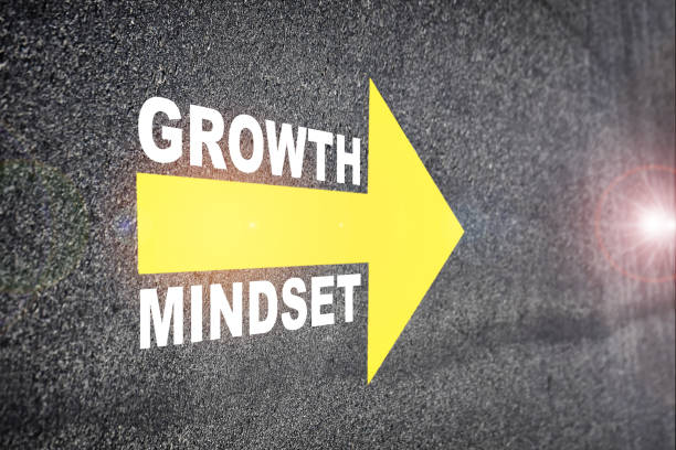 Growth mindset with yellow arrow marking on road surface stock photo
