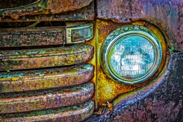 Grungy look of old car front light and grill stock photo