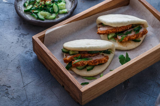 Gua bao, steamed buns, with pork belly, close view Gua bao steamed buns, with pork belly, close view. taiwan food prawn snack stock pictures, royalty-free photos & images