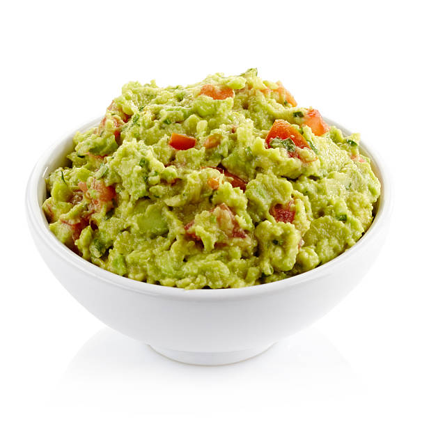 Guacamole dip White bowl of fresh guacamole dip isolated on white background guacamole stock pictures, royalty-free photos & images