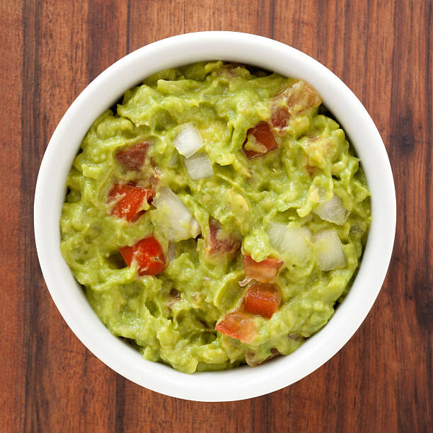 Guacamole  guacamole brown stock pictures, royalty-free photos & images, avocado pits keep guacamole fresh