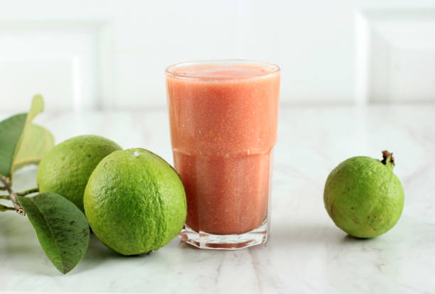Guava juice with guava slice. Mint leaves as a garnish. stock photo