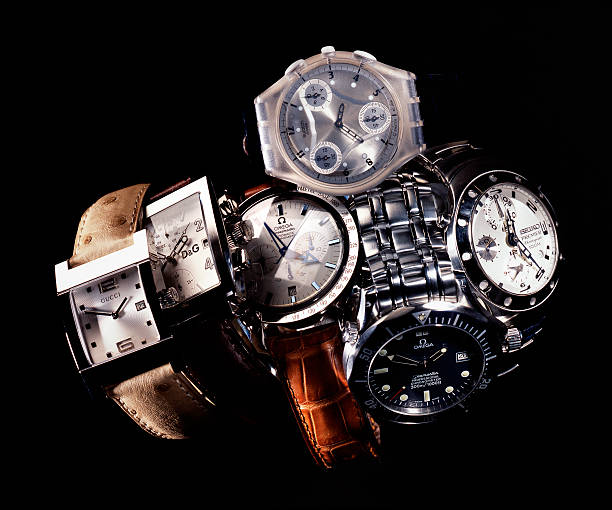 Gucci, Omega, Swatch, Seiko, Dolce & Gabbana luxury wristwatches Leiden, The Netherlands - June 26, 2008: Product shot of a Gucci, Omega, Swatch, Seiko, Dolce & Gabbana wristwatch with leather and metal straps, shot in studio on black background. gucci stock pictures, royalty-free photos & images