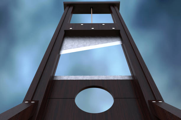 Guillotine instrument for inflicting capital punishment by decapitation Guillotine instrument for inflicting capital punishment by decapitation and dramatic cloud background. Old wooden instrument for execution. Close up 3d Rendering illustration guillotine stock pictures, royalty-free photos & images