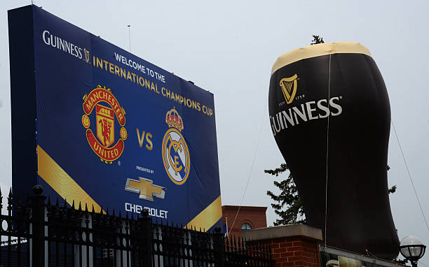 Guinness balloon and Champions Cup sign in Ann Arbor Ann Arbor, MI, USA - August 2, 2014: The Guinness balloon and International Champions Cup sign at Michigan Stadium at the International Champions Cup on August 2, 2014 in Ann Arbor, MI. manchester united stock pictures, royalty-free photos & images