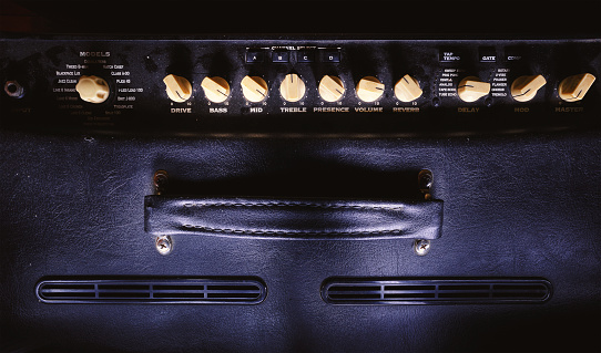 Details of a guitar amplifier, closeup view on preamp and pots.