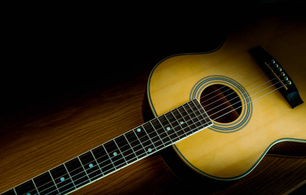Guitar folk on a wooden floor with beautiful light. Guitar folk on a wooden floor with beautiful light. acoustic guitar stock pictures, royalty-free photos & images