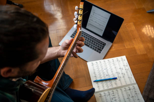 Guitarist composing at home stock photo