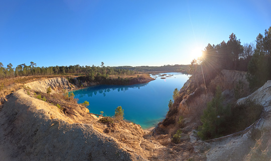 Guizengeard lake at sunset, hike at the spectacular blue lake of the Charente at Lac Bleu de Guizengeard, France, Europe