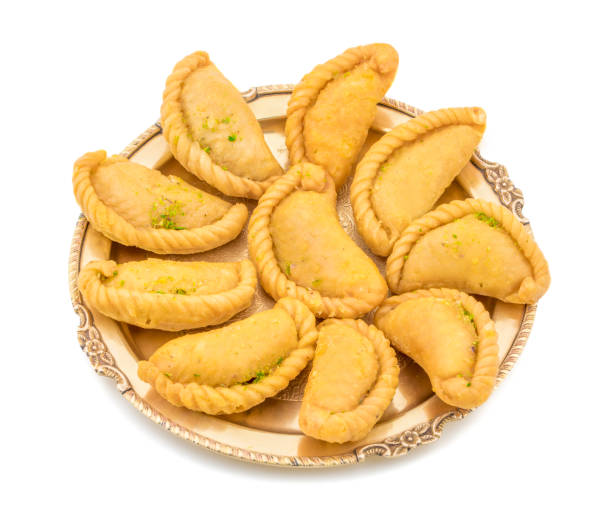 Gujiya or Gujia is a indian sweet food Gujiya or Gujia is a indian sweet dumpling made with suji, Maida or wheat flour and stuffed with khoya. It is common in North India, particularly in Bihar, Uttar Pradesh, Madhya Pradesh or Rajasthan mithai stock pictures, royalty-free photos & images