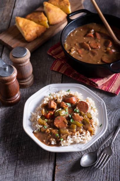 Gumbo Sausage Gumbo Over Rice on Rustic Wood Table okra photos stock pictures, royalty-free photos & images