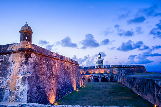 Gun Tower at El Morro Tower and lighthouse at El Morro fort in San Juan, Puerto Rico lit up at night puerto rico stock pictures, royalty-free photos & images
