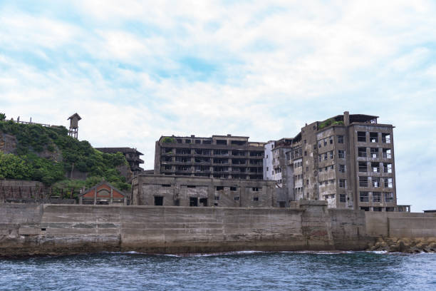 Gunkanjima - Battleship Island in Nagasaki, Japan (UNESCO World Heritage) Uninhabited warship island of Japan in Nagasaki (Hashima) registered as a UNESCO World Heritage Site. Concrete is in ruins hashima island stock pictures, royalty-free photos & images