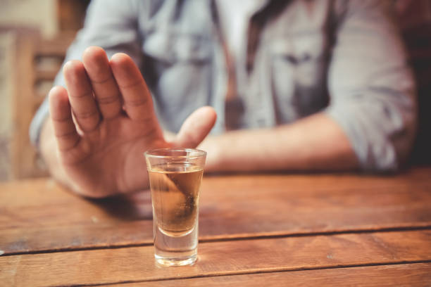 Guy at the pub Cropped image of man showing stop gesture and refusing to drink alcohol abuse stock pictures, royalty-free photos & images