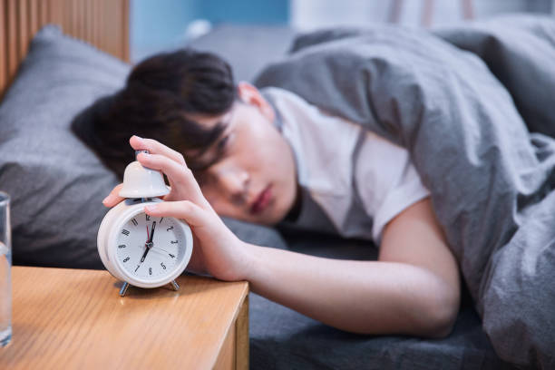 Guy hates getting up early stock photo