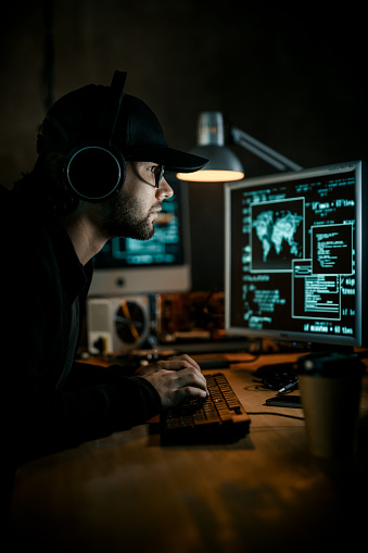 Hacker working on computer. Cyber crime concept.
