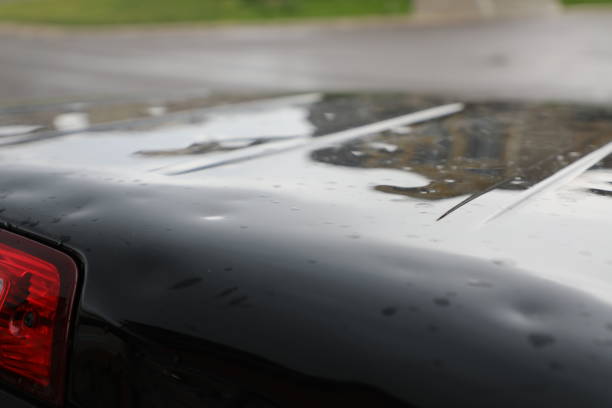 Hail Damage to Truck Hail damage done to black truck roof. Colorado weather insurance claim for repair. dented stock pictures, royalty-free photos & images