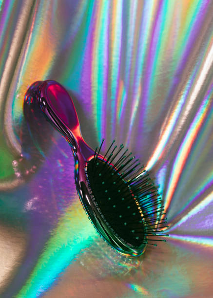 Hairbrush on holographic background stock photo