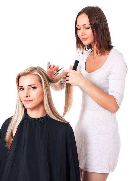 Hairdresser cutting hair isolated on white stock photo