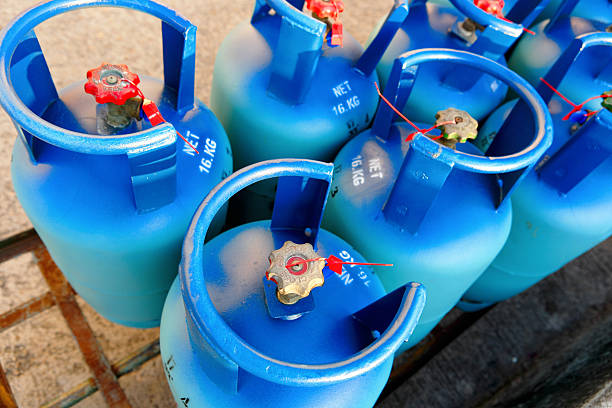 Half a dozen blue propane tanks stock photo