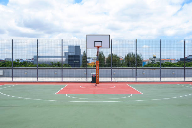 Half Court View Of An Empty Basketball Court On A Sunny Day. With Dramatic Sky stock photo
